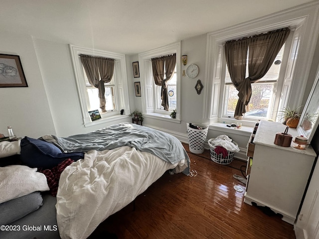 bedroom with dark wood-type flooring