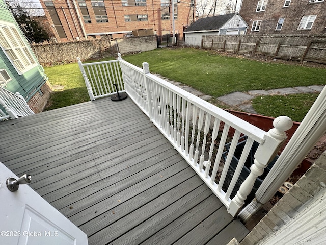 wooden deck with a lawn