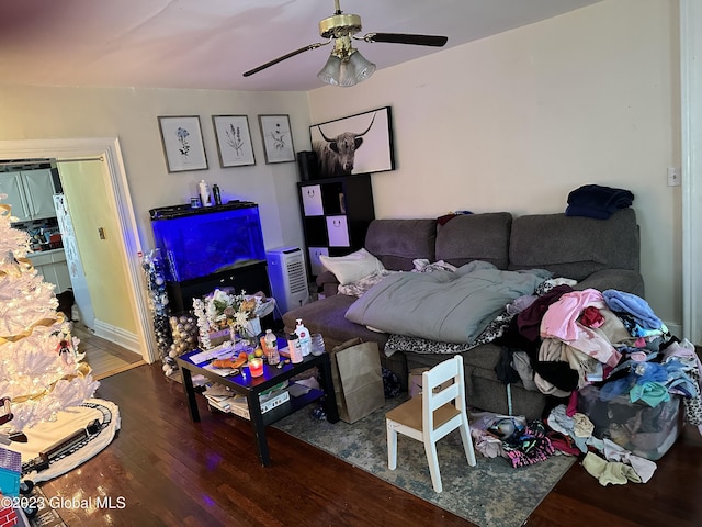 living room featuring ceiling fan and hardwood / wood-style floors