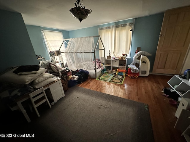 bedroom with dark hardwood / wood-style floors