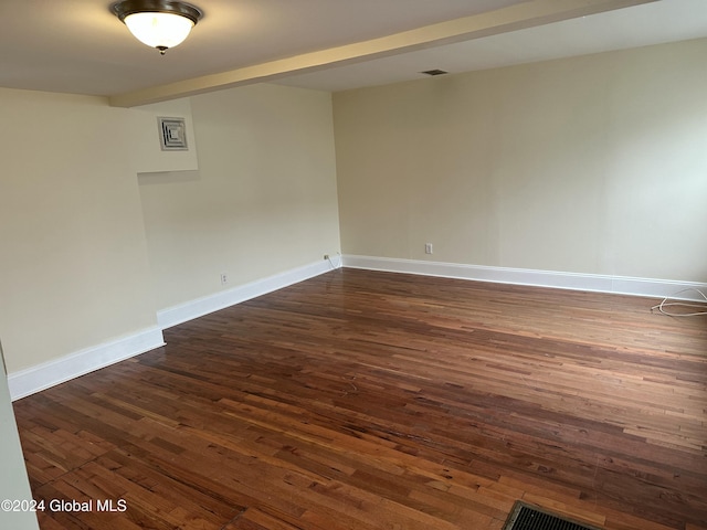 spare room featuring dark wood-type flooring