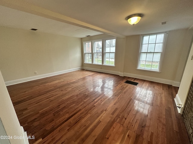 unfurnished room featuring dark hardwood / wood-style flooring