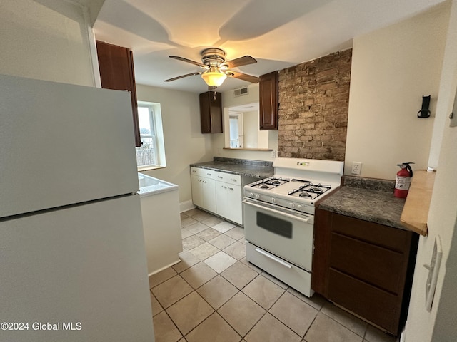 kitchen with ceiling fan, dark brown cabinets, light tile patterned floors, and white appliances