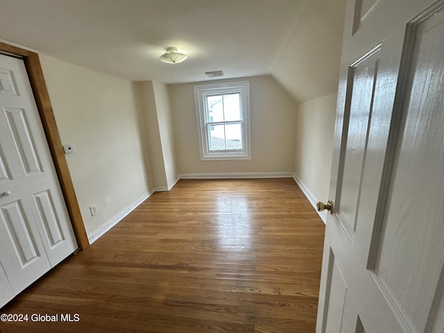 bonus room featuring wood-type flooring and vaulted ceiling