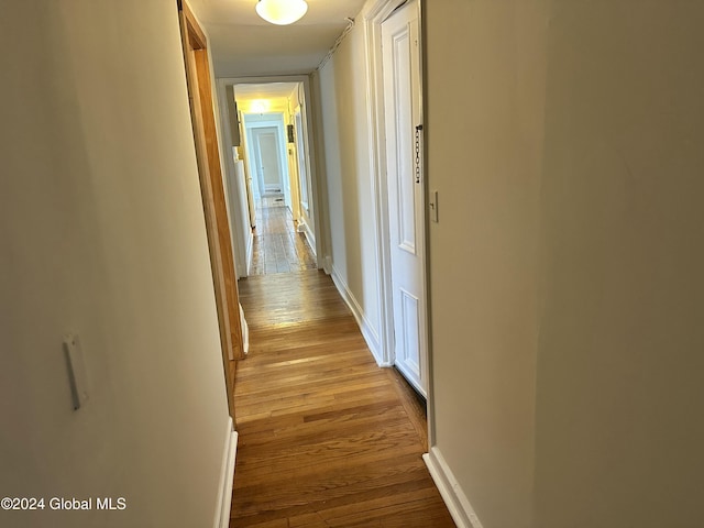 hallway with light hardwood / wood-style flooring