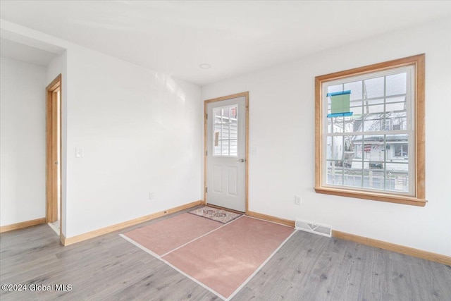 entryway with visible vents, baseboards, and wood finished floors