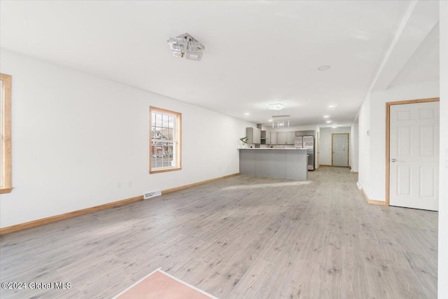 unfurnished living room featuring recessed lighting, visible vents, baseboards, and light wood-style floors