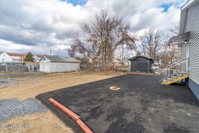 view of yard with an outdoor structure and fence