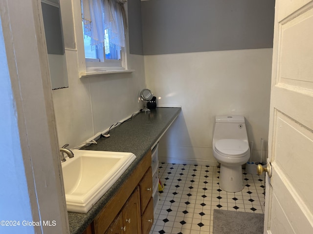 bathroom featuring toilet and vanity