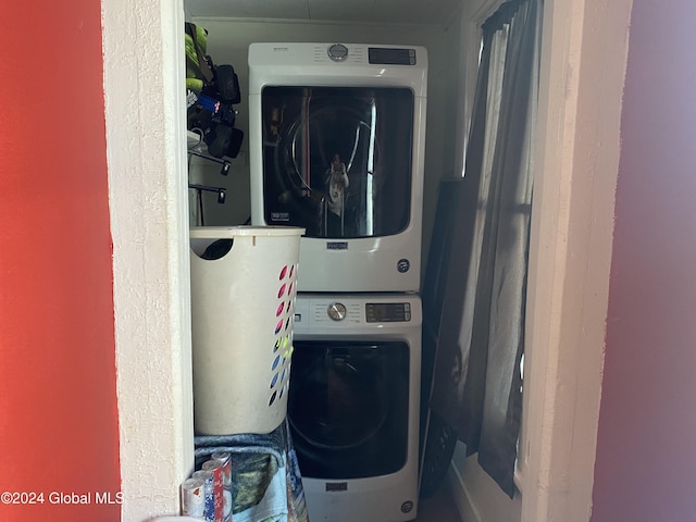 laundry area with stacked washer and clothes dryer