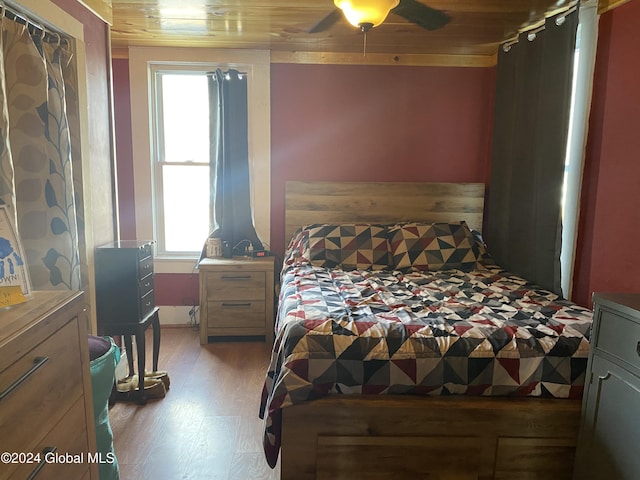 bedroom with light wood-type flooring, ceiling fan, and wood ceiling