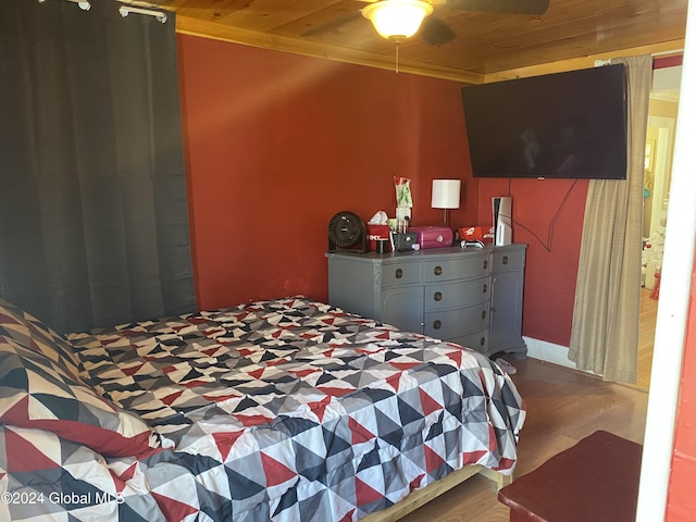 bedroom with ceiling fan, wood ceiling, ornamental molding, and hardwood / wood-style flooring