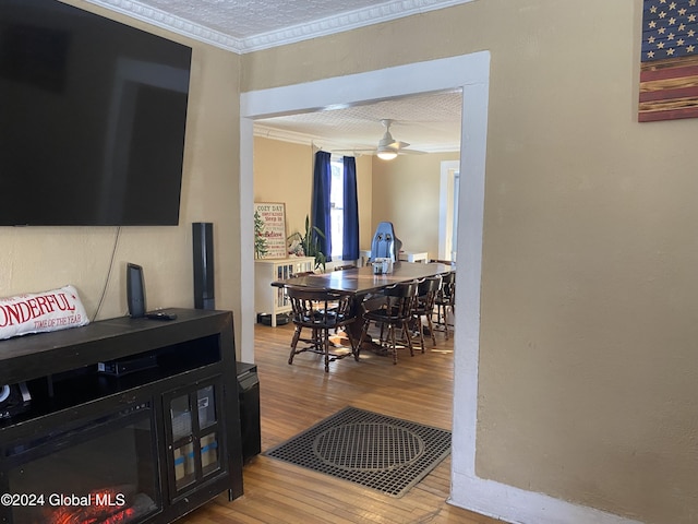 interior space featuring ceiling fan, hardwood / wood-style floors, crown molding, and a textured ceiling