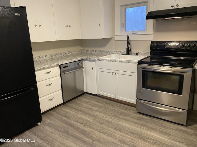 kitchen featuring stainless steel range with electric stovetop, white cabinetry, light hardwood / wood-style floors, black fridge, and sink