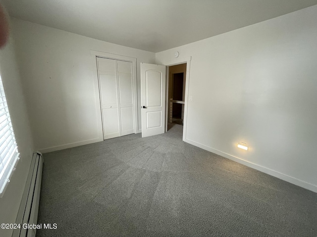 unfurnished bedroom with a closet, carpet, and a baseboard radiator