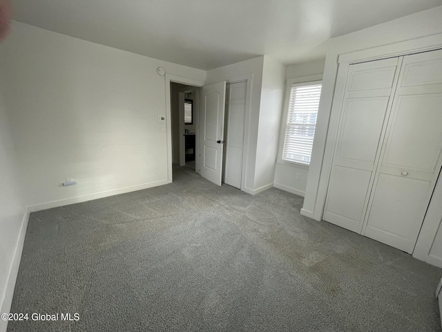 unfurnished bedroom featuring a closet and carpet floors