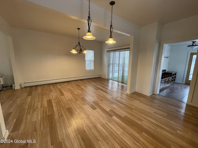 unfurnished dining area featuring baseboard heating, a notable chandelier, and hardwood / wood-style flooring