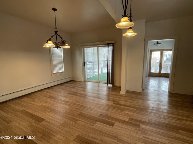 unfurnished dining area with a chandelier, wood-type flooring, a baseboard radiator, and french doors