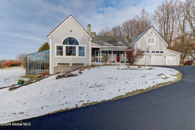 view of front of property with covered porch and a garage