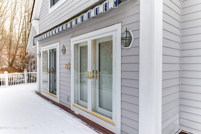 view of snow covered property entrance