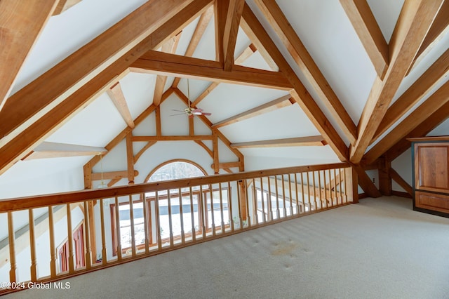 hallway with carpet flooring, beamed ceiling, and high vaulted ceiling