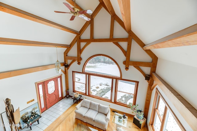 living room featuring ceiling fan, high vaulted ceiling, and light tile patterned floors