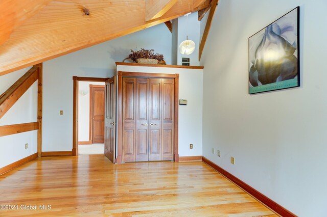 unfurnished bedroom featuring light hardwood / wood-style floors and vaulted ceiling