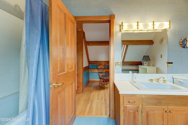 bathroom with vanity, hardwood / wood-style floors, and shower / bathtub combination with curtain