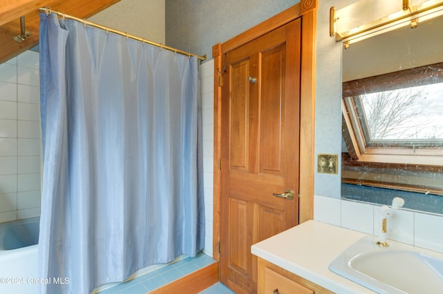 bathroom featuring a shower with curtain, vanity, a skylight, and tile patterned floors