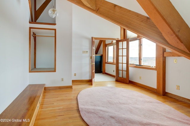 bonus room with high vaulted ceiling and light hardwood / wood-style flooring