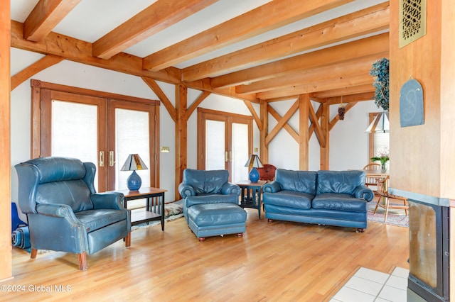 living room featuring hardwood / wood-style floors, beamed ceiling, and french doors