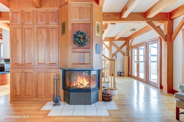 living room with light hardwood / wood-style floors and beam ceiling