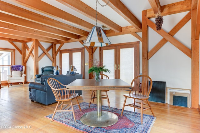 dining area featuring beam ceiling, french doors, and wood-type flooring