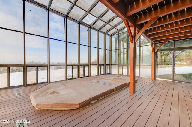 unfurnished sunroom with a water view and lofted ceiling