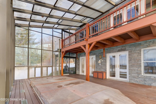 unfurnished sunroom featuring a wealth of natural light and vaulted ceiling