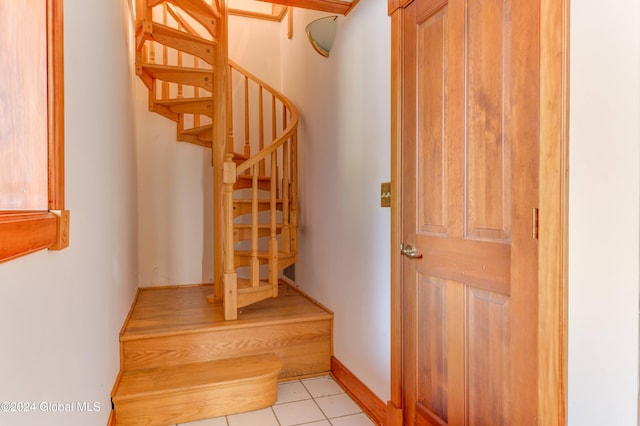 stairway with tile patterned flooring