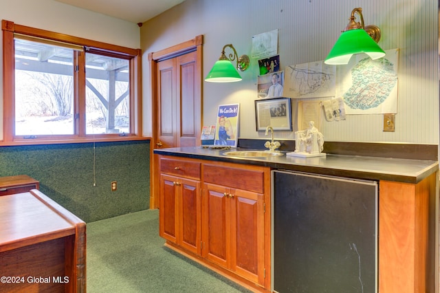 kitchen featuring stainless steel fridge, sink, and carpet