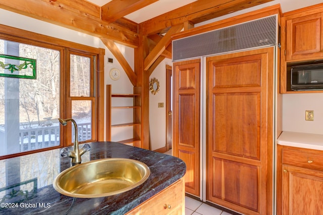 bathroom with tile patterned floors, plenty of natural light, and sink