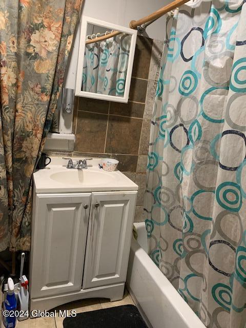 bathroom with shower / bath combination with curtain and vanity