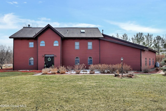 back of house with a yard