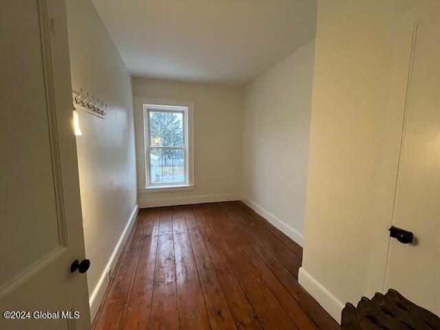 unfurnished room with dark hardwood / wood-style flooring