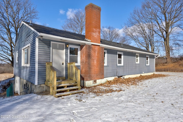 view of snow covered rear of property