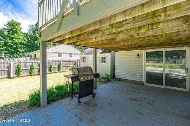 deck with an outbuilding, a yard, and area for grilling