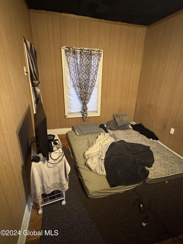 bedroom featuring wood walls