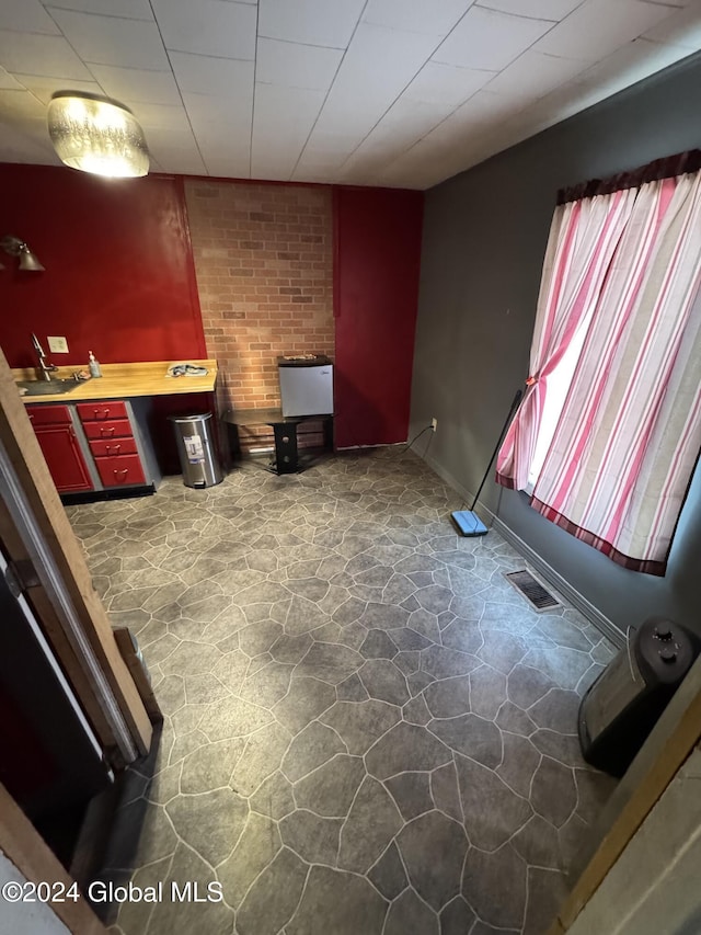 unfurnished living room featuring sink