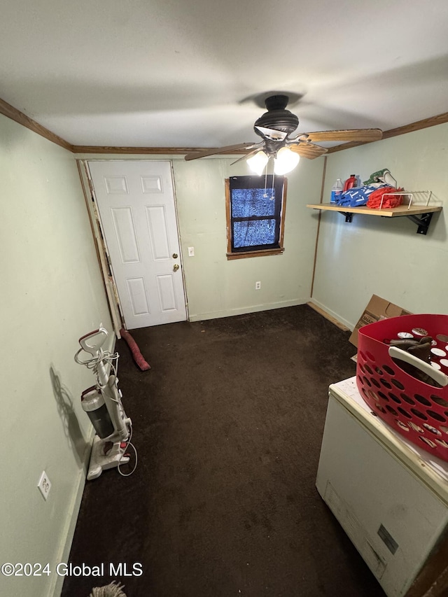 misc room featuring crown molding, ceiling fan, and dark carpet