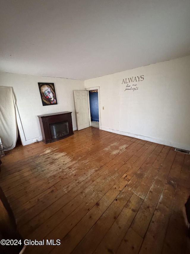 unfurnished living room featuring dark hardwood / wood-style flooring