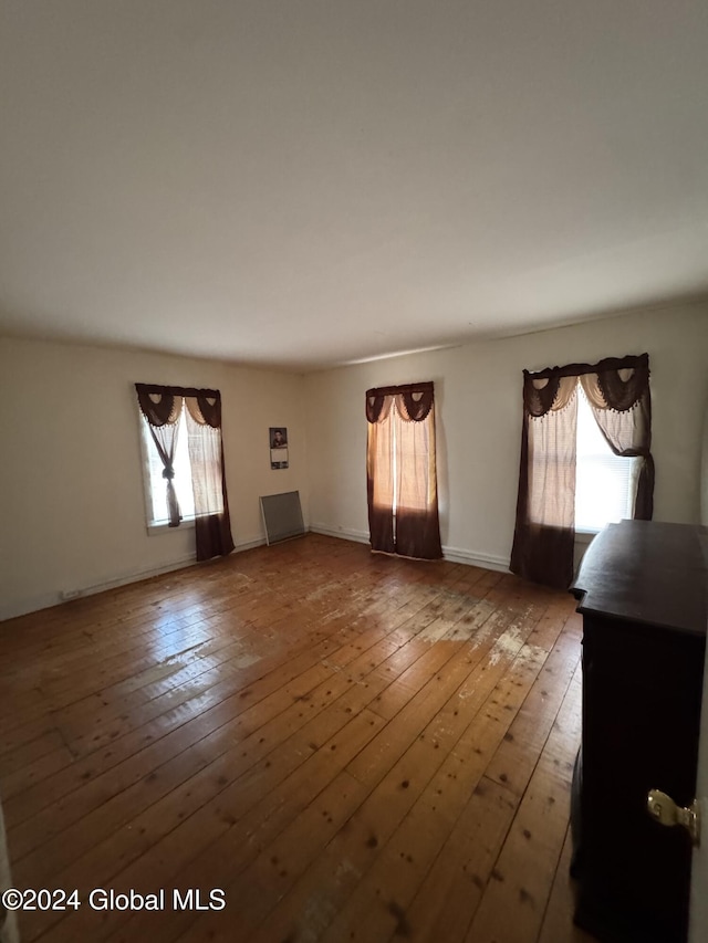 unfurnished living room featuring wood-type flooring