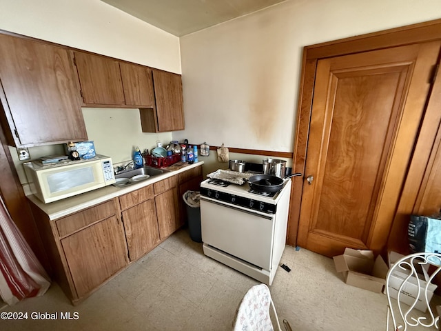 kitchen featuring white appliances and sink