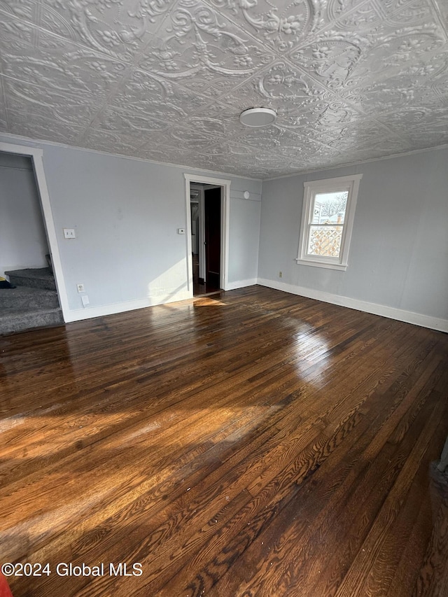 spare room with a textured ceiling and dark hardwood / wood-style flooring